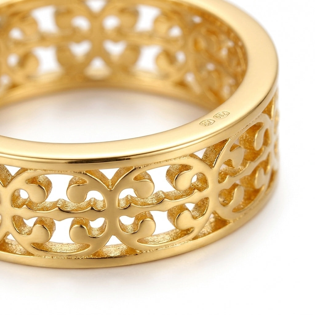 A close-up of a gold filigree ring with an intricate openwork pattern, showing a polished 925 sterling silver hallmark on the inside, set against a clean white background.