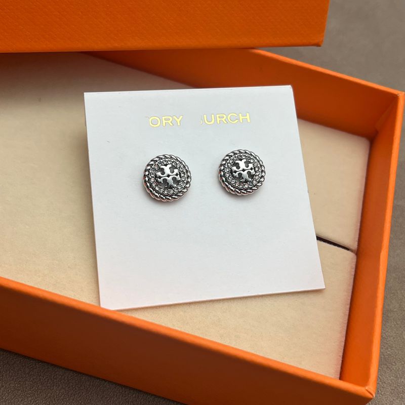 Both earrings displayed face-up on a dark, smooth surface (black marble), highlighting the contrast between the textured rope border and crystal sparkle.