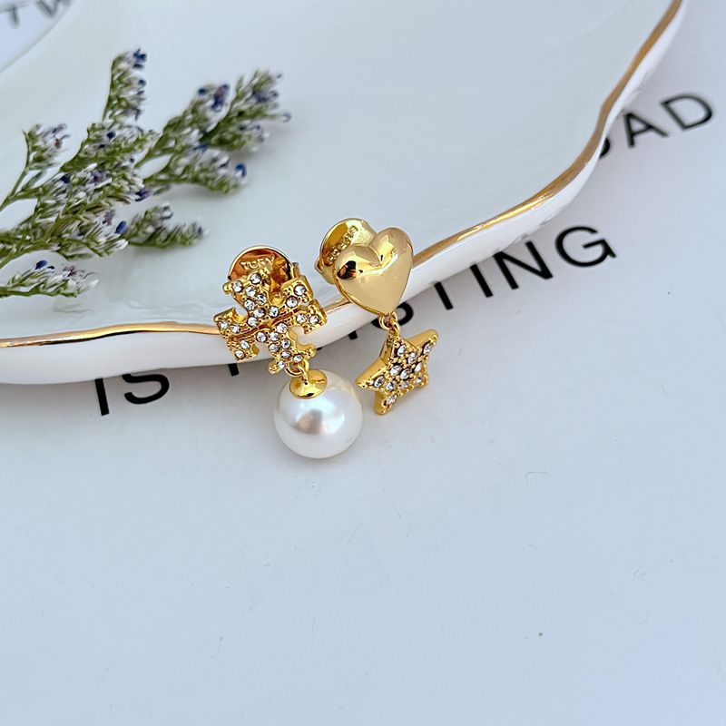 All three charms displayed together on a light, playful background, showing the pearl, heart, and star clearly.