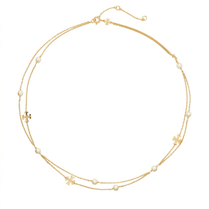 A delicate double-strand gold necklace with small white pearl beads and gold cross charms, displayed on a clean white background.
