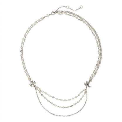 A silver-toned multi-strand necklace featuring delicate chain layers, small bead details, and two star-shaped crystal embellishments on a plain white background.