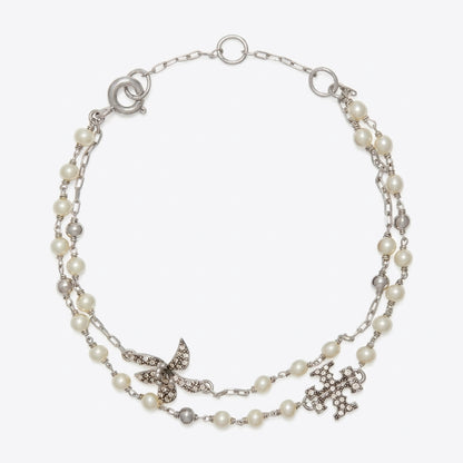 A silver-tone double-strand necklace featuring white faux pearls, a silver butterfly embellished with clear rhinestones, and a silver cross pendant, displayed on a light gray background.