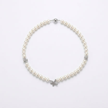 A pearl necklace with silver-toned butterfly and floral accents, displayed on a clean white background.