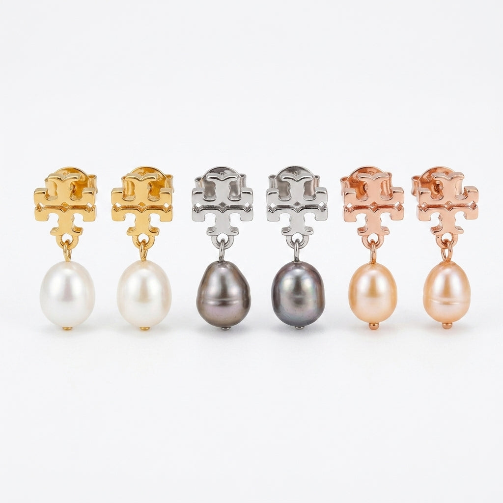 Set of pearl earrings in gold, silver, and rose gold on a white background