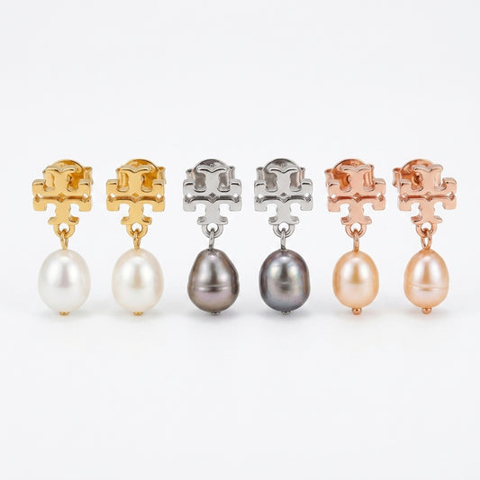 Set of pearl earrings in gold, silver, and rose gold on a white background