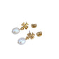 Gold earrings with pearl drops on a white background
