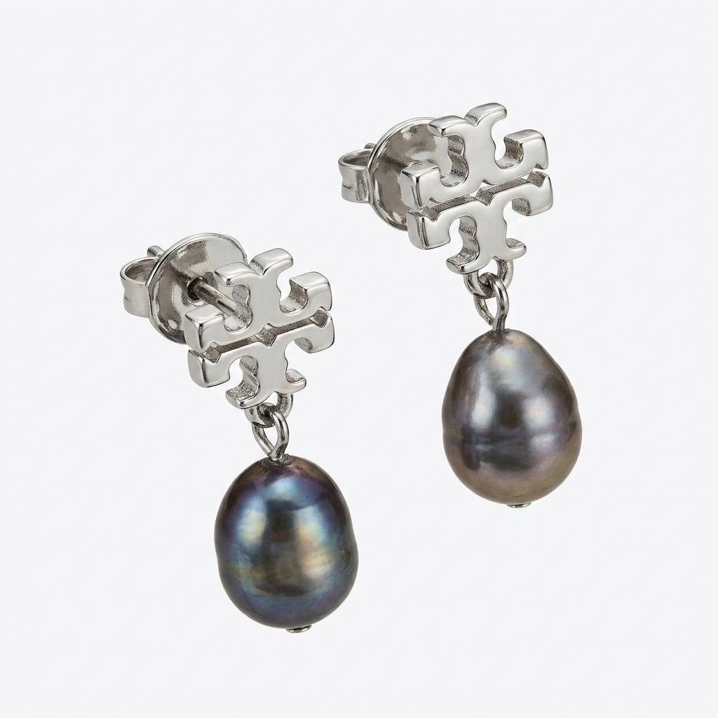 Pair of silver earrings with black pearls on a white background