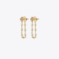 Gold earrings with pearl chains on a white background