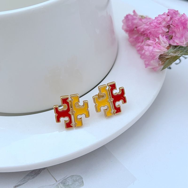 Clean shot of a single stud against a soft, neutral background, showcasing the wavelike metal frame and the iridescent play of color on the mother-of-pearl.