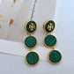 Green marbled earrings with gold accents on a light background
