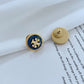 Gold and blue earring on a book page