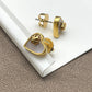 Close-up focusing on the heart shape, highlighting the natural iridescent play of color in the mother of pearl and the gold-tone setting.