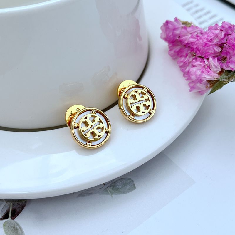 Clean shot of a single stud against a soft, neutral background, showcasing the beautiful iridescent colors of the mother-of-pearl and the gold setting.