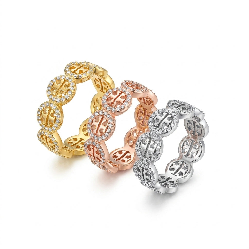 Three stacked eternity rings with circular Chinese character motifs, shown in yellow gold, rose gold, and silver white gold settings, each surrounded by small clear pavé stones on a white background.