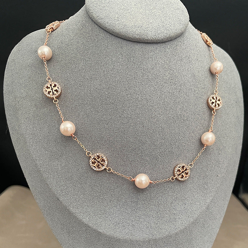 The necklace worn with both a crisp white shirt (day) and a simple black top (evening) to demonstrate its versatile elegance.