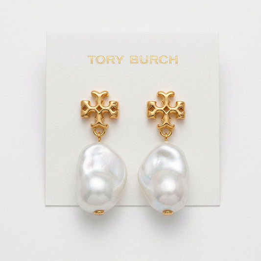Tory Burch gold-tone cross stud earrings with large baroque white pearls, displayed on a white brand card.