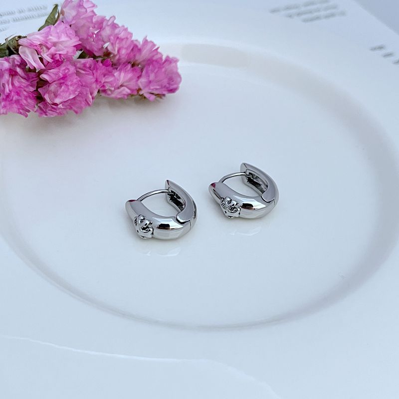 Both hoops displayed on a dark, non-reflective background to maximize the brilliance of the crystal section against the metal.