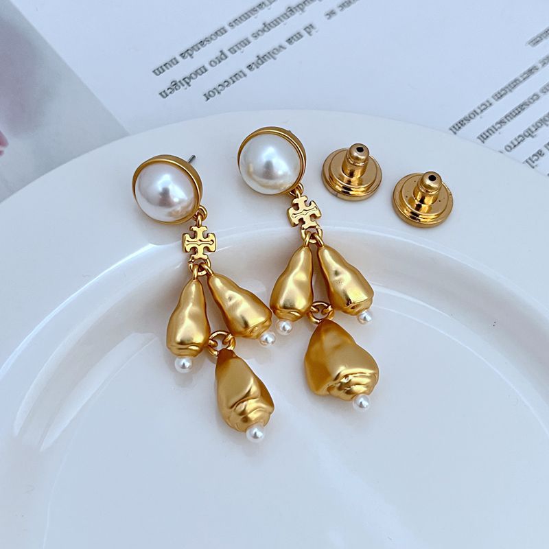  Vertical, elegant shot of a single earring against a dark, muted background to highlight the intricate details and sparkle of the chandelier design.