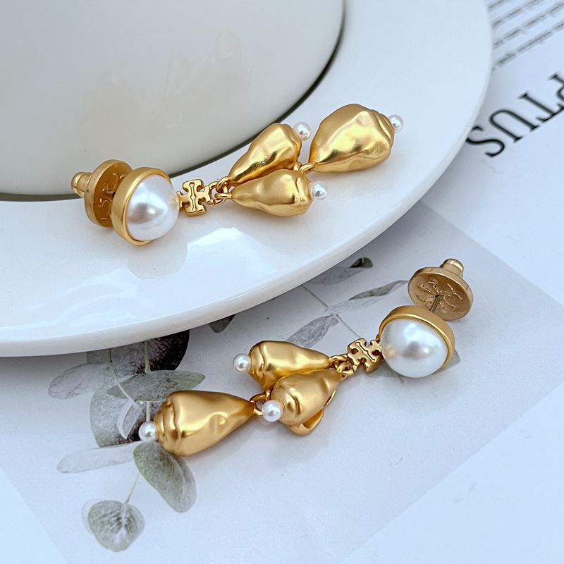  Vertical, elegant shot of a single earring against a dark, muted background to highlight the intricate details and sparkle of the chandelier design.