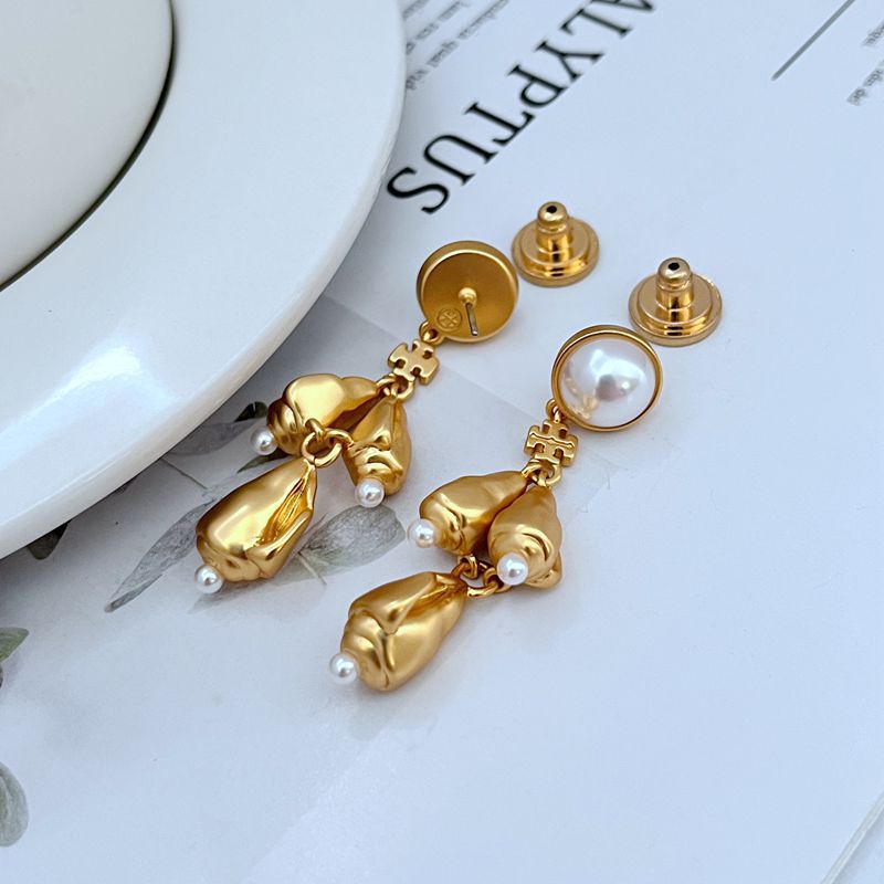  Vertical, elegant shot of a single earring against a dark, muted background to highlight the intricate details and sparkle of the chandelier design.