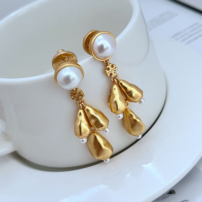  Vertical, elegant shot of a single earring against a dark, muted background to highlight the intricate details and sparkle of the chandelier design.