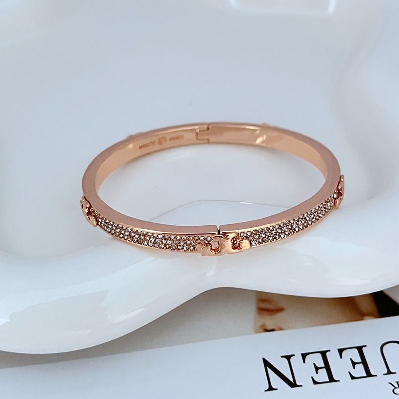 Bangle displayed inside its original, pristine Tory Burch box, showcasing its new, untouched condition.