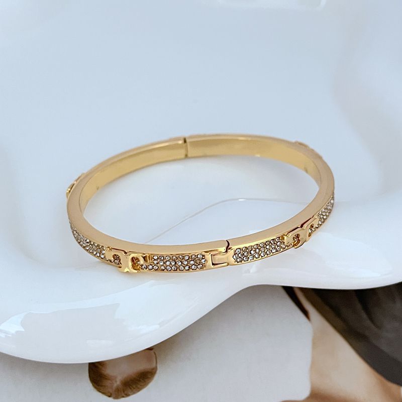 Bangle displayed inside its original, pristine Tory Burch box, showcasing its new, untouched condition.