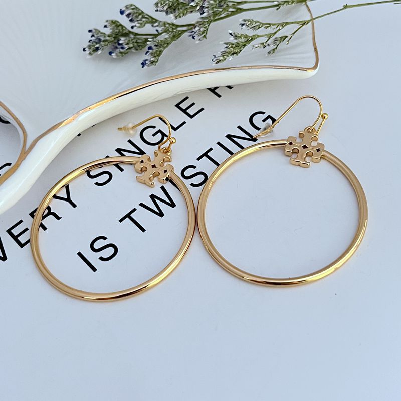 Tory Burch Rose Gold T Logo Hoop Earrings on a neutral background, showcasing the iconic logo and warm rose gold tone."