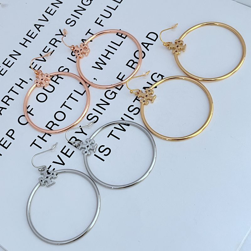 Rose gold Tory Burch Double T logo hoop earrings, featuring a stylish and elegant design for women.