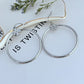 Tory Burch Rose Gold T Logo Hoop Earrings on a neutral background, showcasing the iconic logo and warm rose gold tone."
