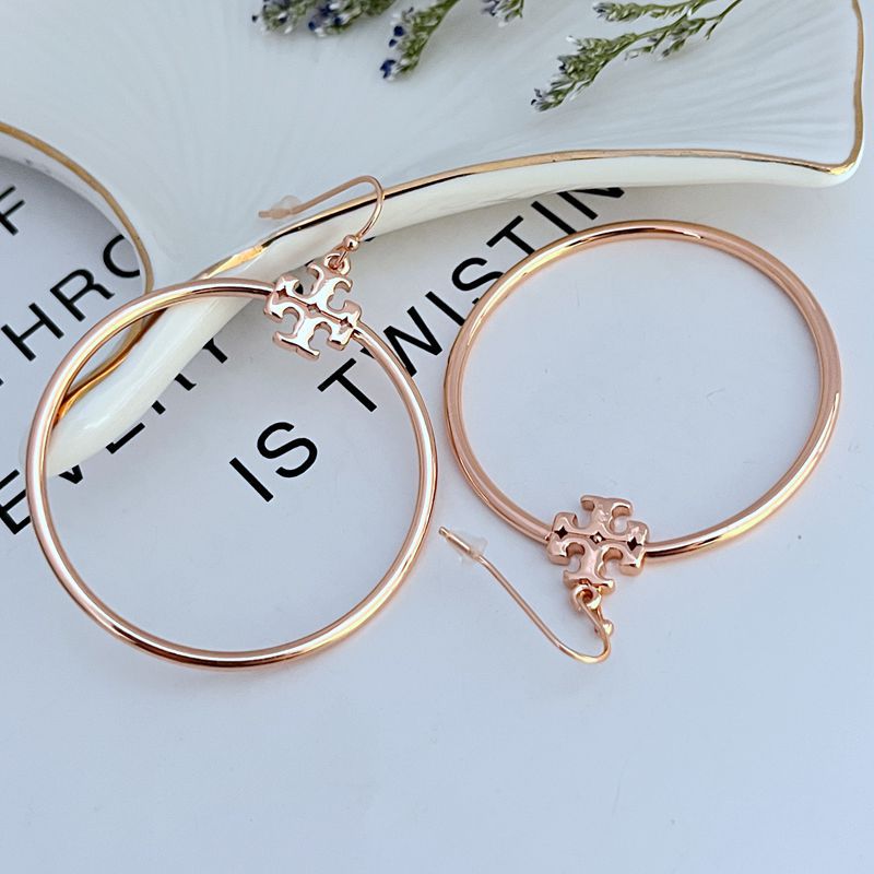 Tory Burch Rose Gold T Logo Hoop Earrings on a neutral background, showcasing the iconic logo and warm rose gold tone."