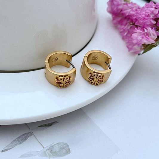 Both earrings displayed face-up on a light gray or white background, with a ruler or scale reference clearly showing the 1.5cm diameter.