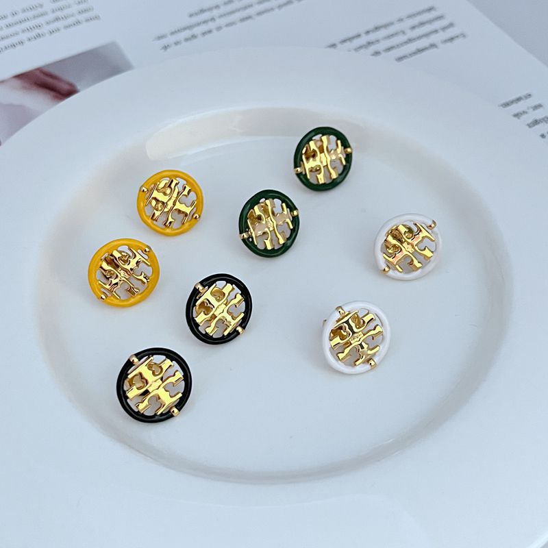 Macro shot focused on the seam where the enamel and metal meet, showcasing the precision of the color division and the smooth, glossy finish of both materials.

