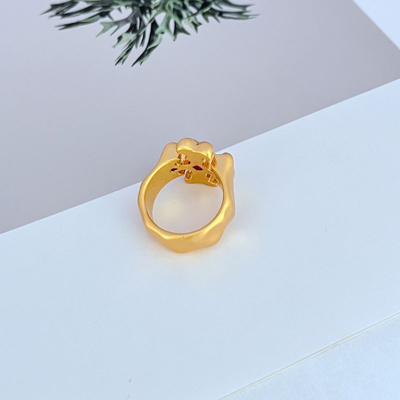 Clean, well-lit shot of the ring on a neutral background or velvet ring pad, highlighting the warm Tory Gold finish and the Double T logo.