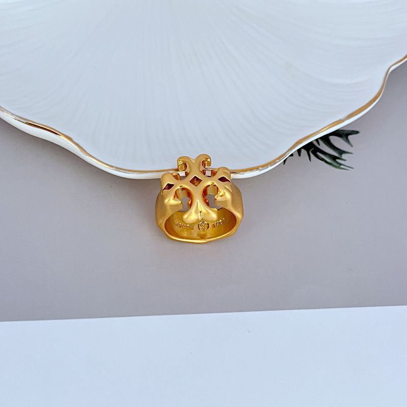 Clean, well-lit shot of the ring on a neutral background or velvet ring pad, highlighting the warm Tory Gold finish and the Double T logo.