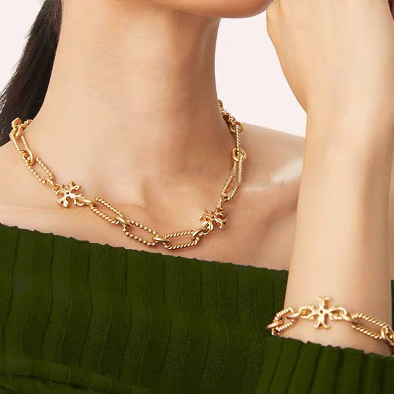 The necklace worn with a simple solid-color top (like black or white), showing how it catches light subtly for daytime elegance.