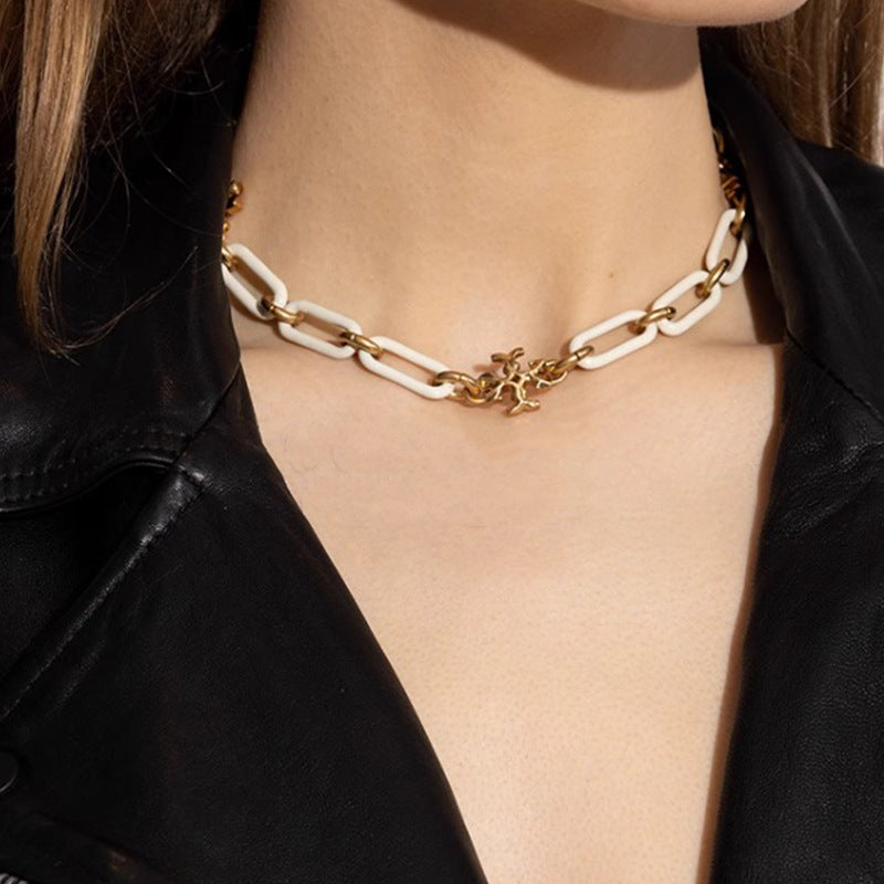 Necklace worn with a crewneck or open-collared shirt, showing how it rests snugly at the base of the neck for a clean, tailored look.