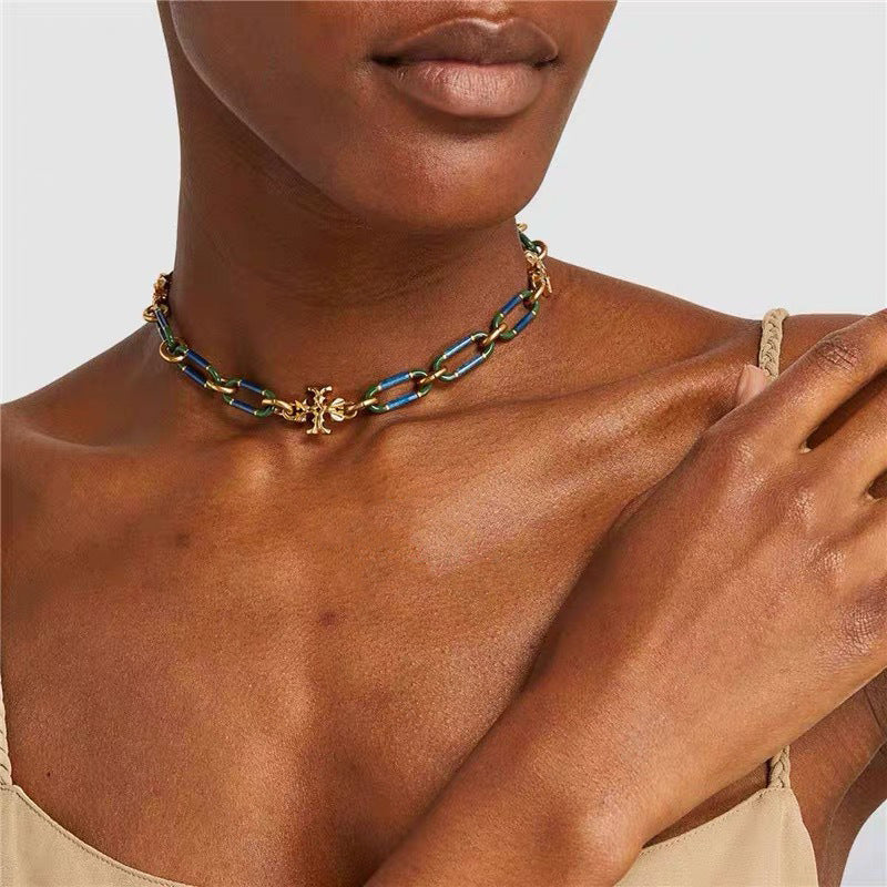 Necklace worn with a crewneck or open-collared shirt, showing how it rests snugly at the base of the neck for a clean, tailored look.