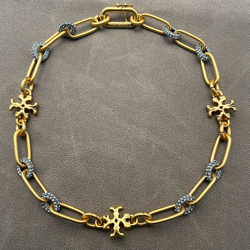 Necklace laid flat on a cool-toned background (e.g., slate gray or white marble), highlighting the silver sheen and clean lines of the chain and pendant.