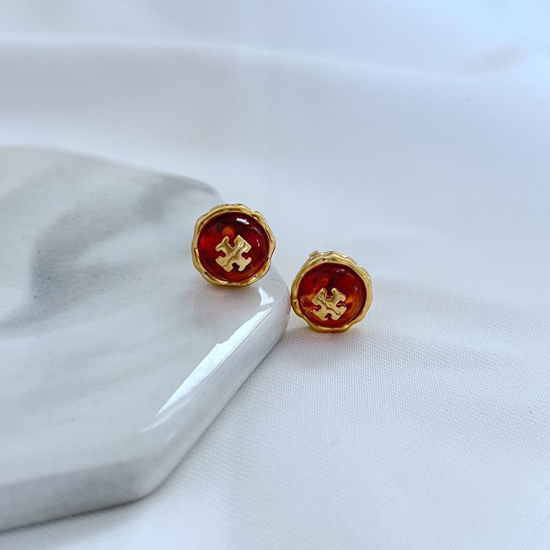  Macro shot focused on the stone, highlighting its unique veins, inclusions, polish, and how it is seamlessly set within the metal logo.