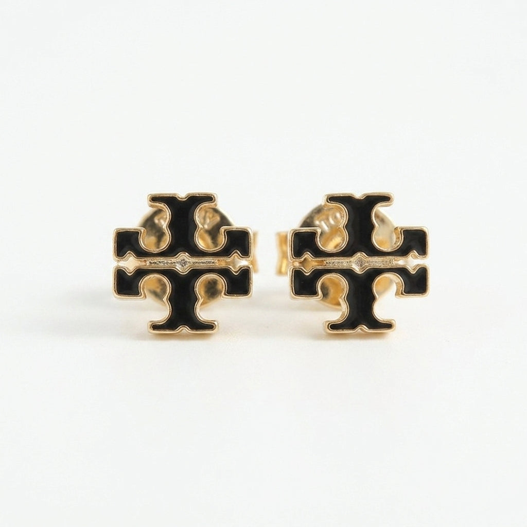 A pair of gold and black cross-shaped stud earrings on a clean white background.