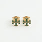 A pair of gold-tone stud earrings featuring a green enamel interlocking monogram design, displayed on a clean white background.