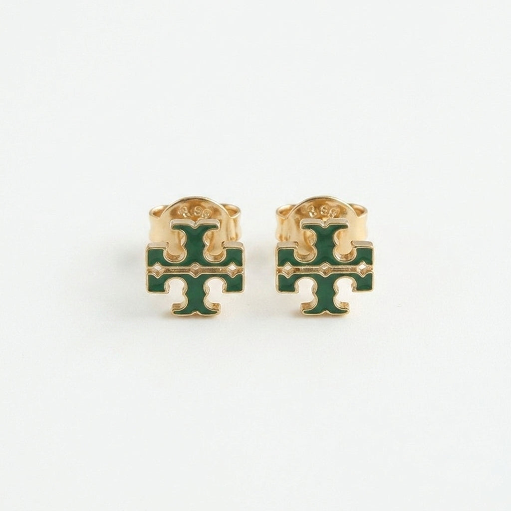 A pair of gold-tone stud earrings featuring a green enamel interlocking monogram design, displayed on a clean white background.