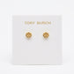 A pair of gold stud earrings with the Tory Burch logo, displayed on a white brand card against a white background.