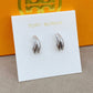 High-definition shot of the pair of earrings laid flat on pure white background, arranged symmetrically.