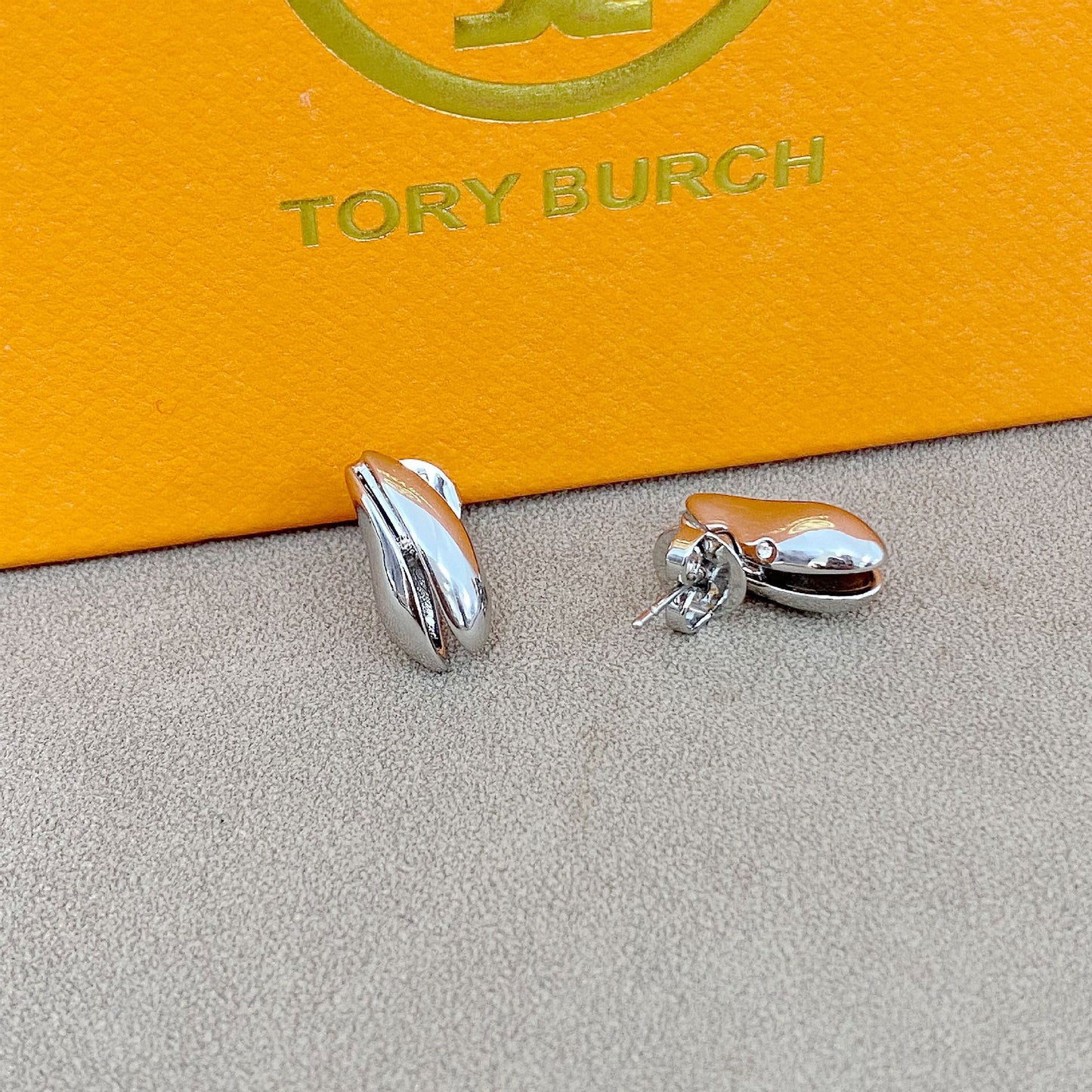 High-definition shot of the pair of earrings laid flat on pure white background, arranged symmetrically.