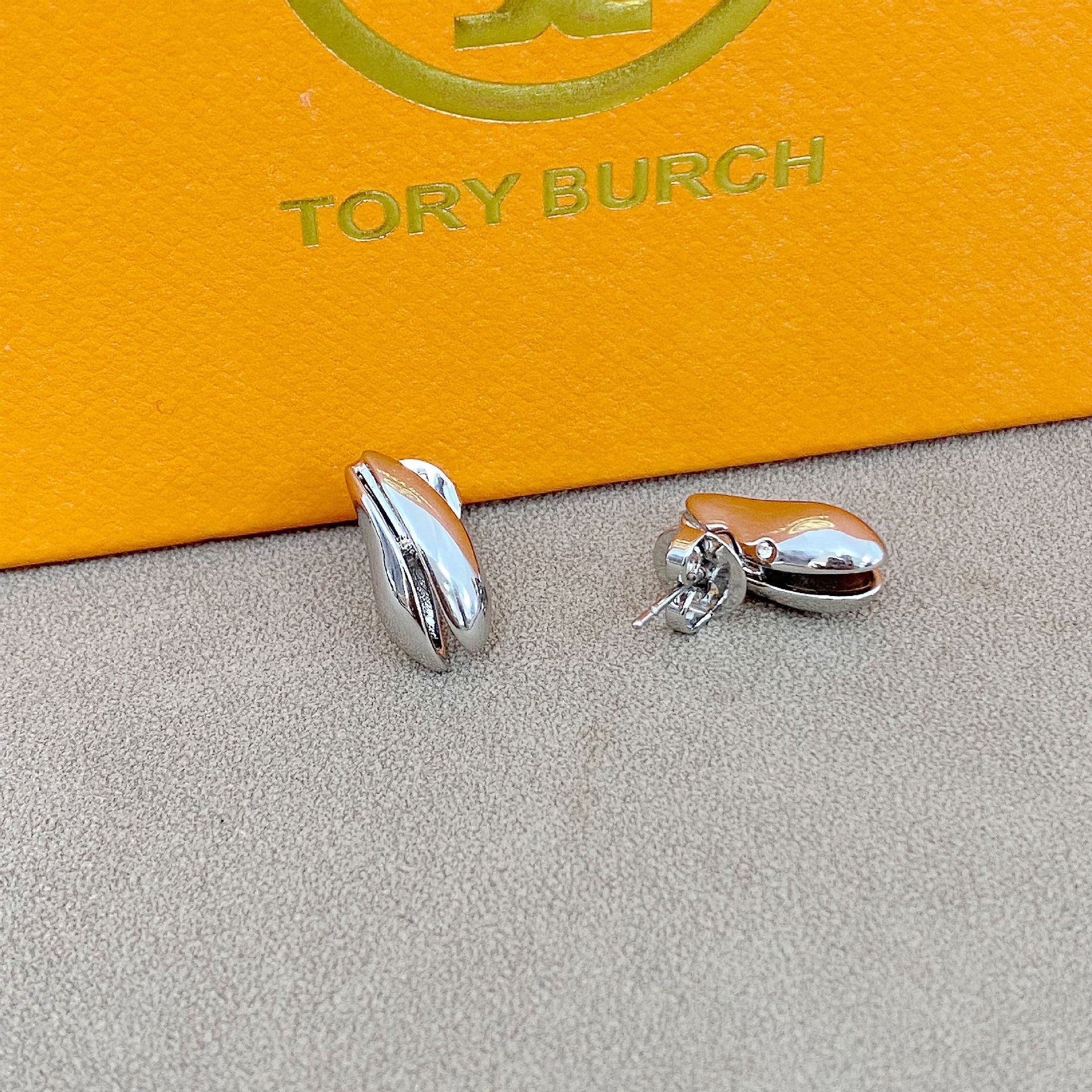 High-definition shot of the pair of earrings laid flat on pure white background, arranged symmetrically.