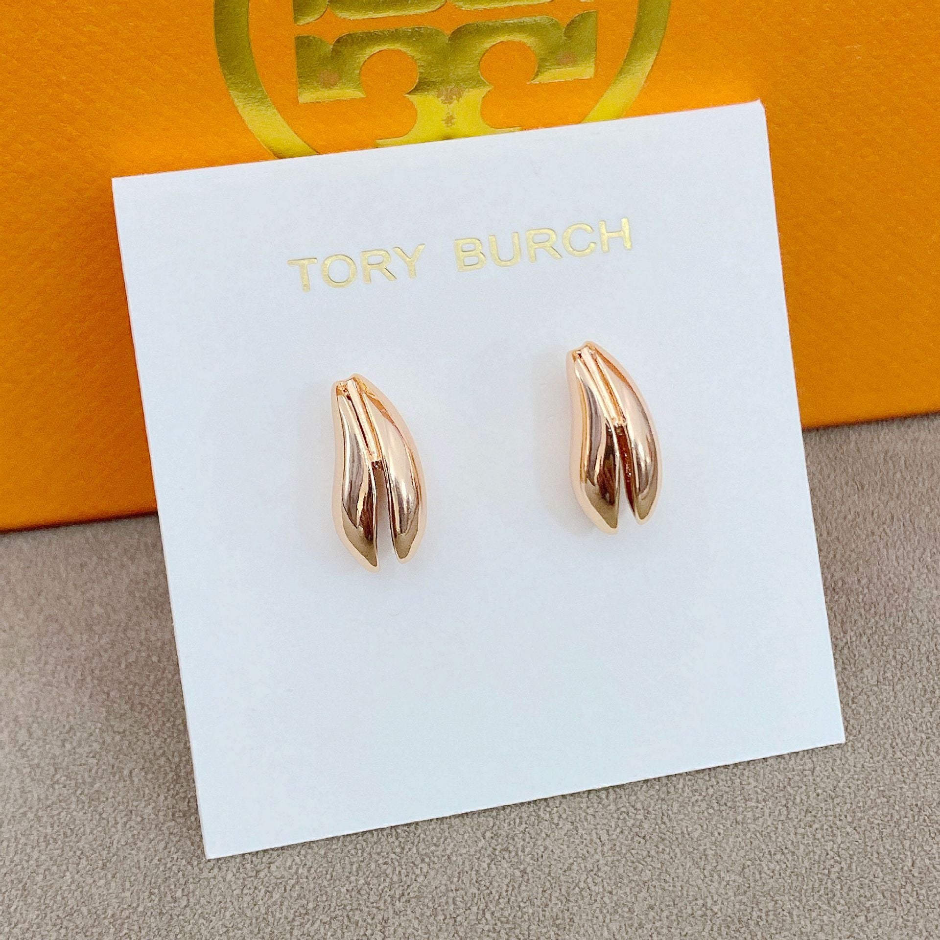 High-definition shot of the pair of earrings laid flat on pure white background, arranged symmetrically.