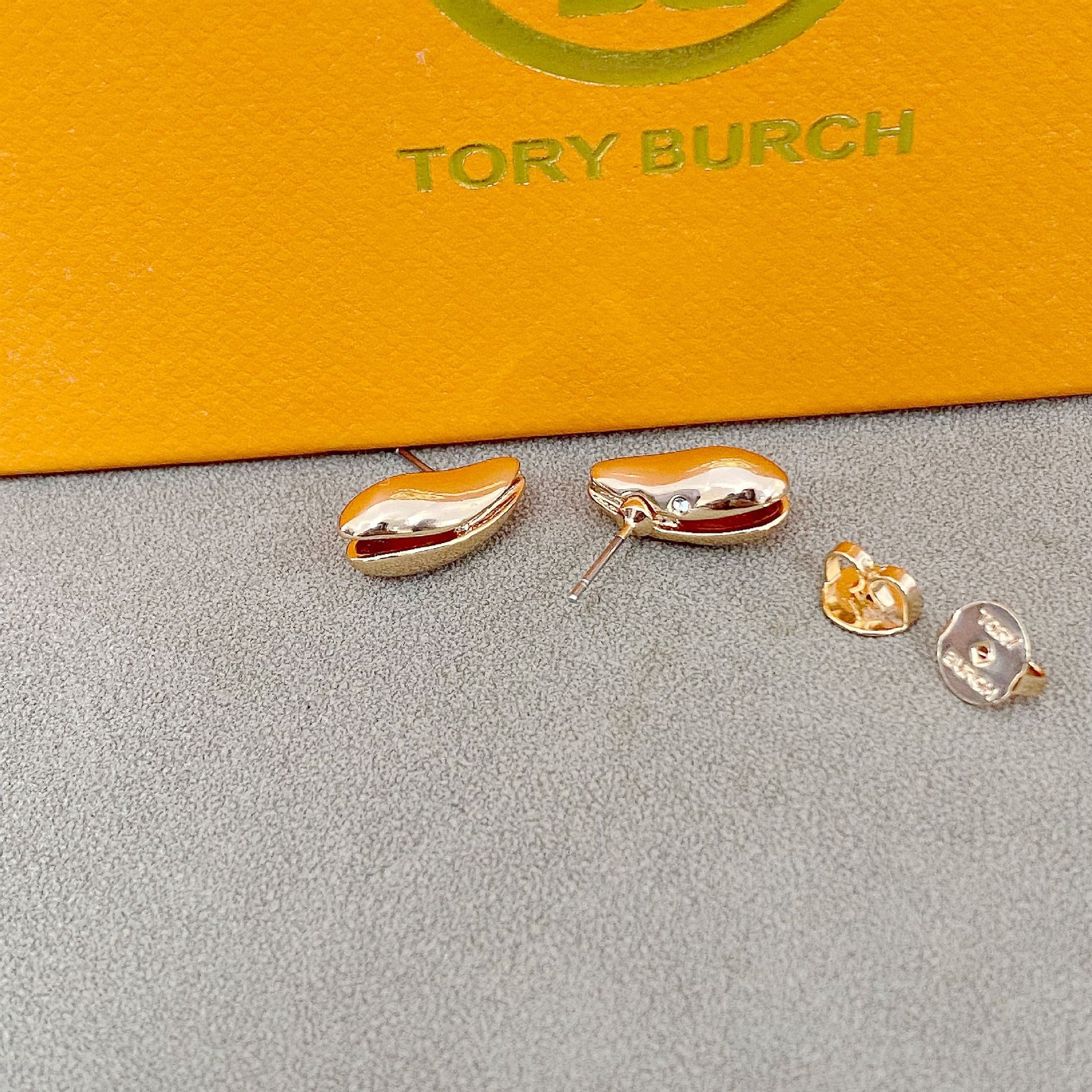 High-definition shot of the pair of earrings laid flat on pure white background, arranged symmetrically.