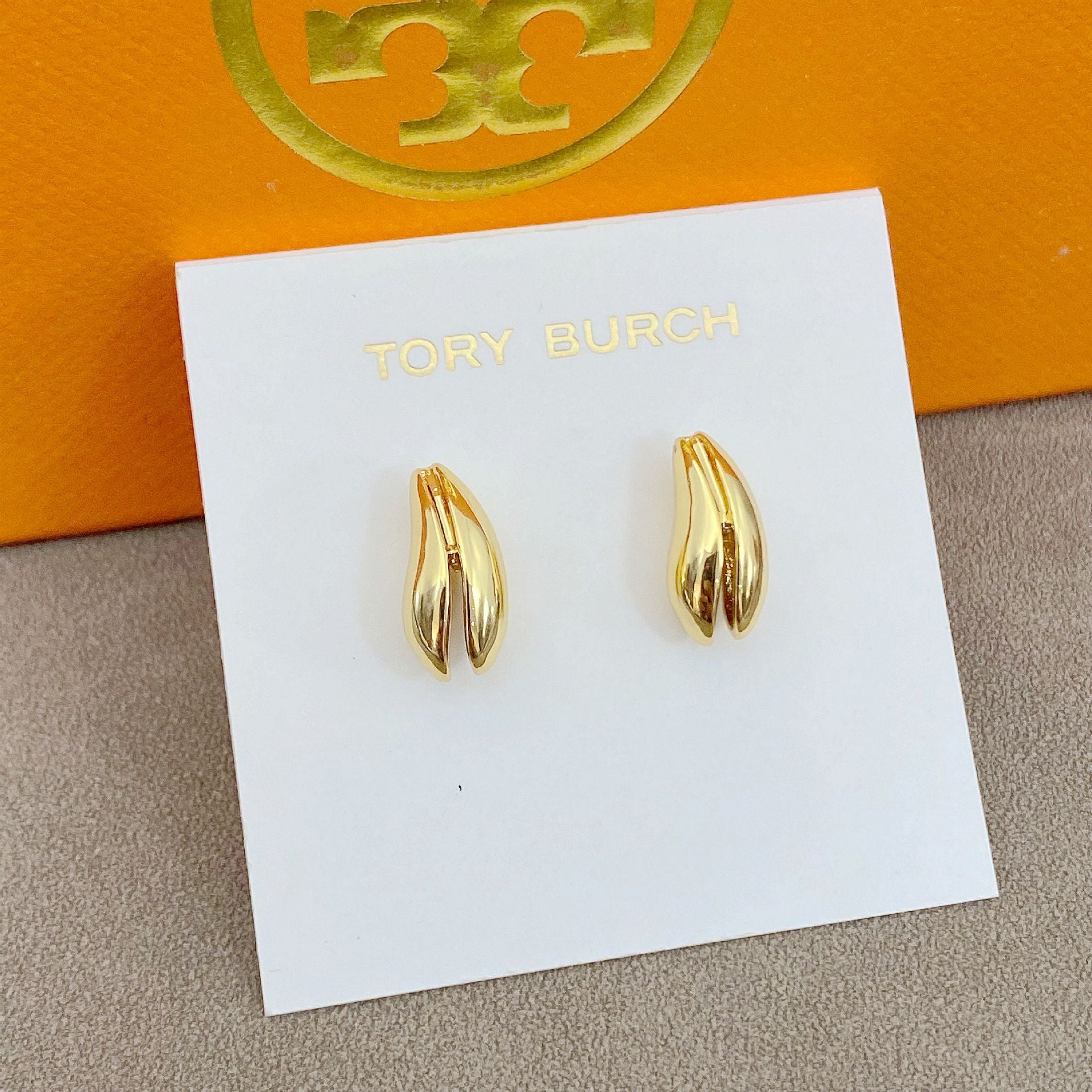 High-definition shot of the pair of earrings laid flat on pure white background, arranged symmetrically.